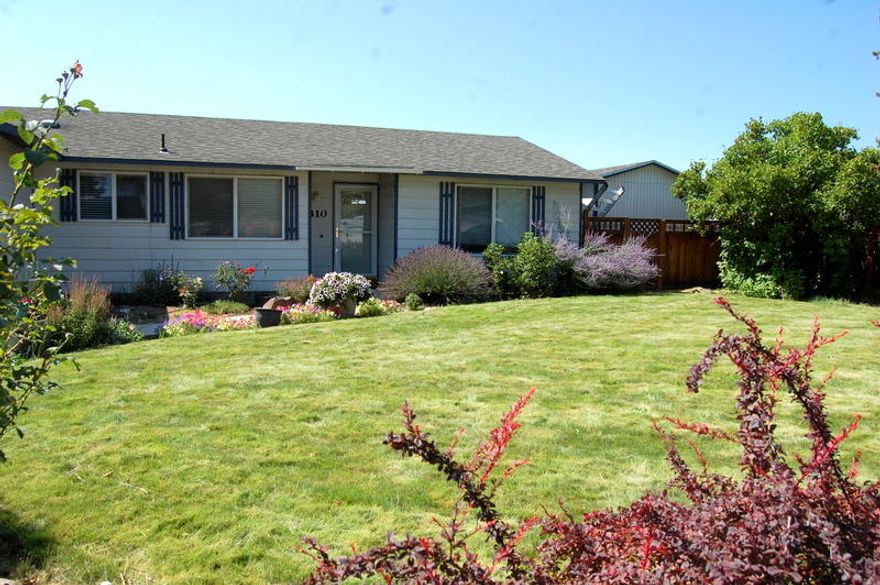 Investors take note! Comfortable cottage with built in Lessee for a year. 2 bedroom, 1 bath, 820 sq ft home built in 1974. Hickory cabinets, pantry area and stainless appliances make the kitchen sparkle. Open concept from kitchen to dining and living room areas. 2nd bedroom is being used for an office den with french doors. Slider from living room to covered patio & fenced back yard with garden area, raised beds and two storage sheds. Seller will have the roof replaced prior to closing. Nicely landscaped front yard with sprinkler system and room to park an RV plus single attached garage.