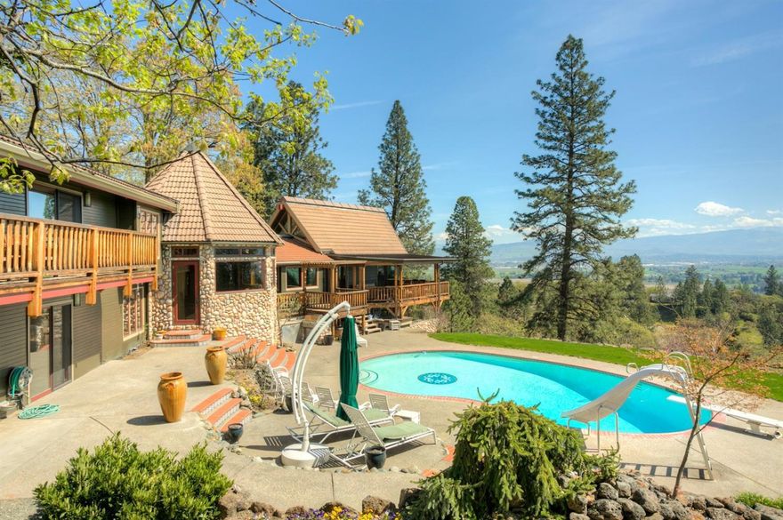 Acorn Hill House is like owning your own luxury lodge! This custom lodge style home is uniquely one of a kind. Hidden behind the privacy of a long private driveway, this property boasts manicured grounds, pool, porches & patios, built in BBQ, 3 stall horse barn, waterfall, hot tub, sport court w/ outdoor lighting, separate craft studio, rock retaining walls, & garden area. The residence features 25 foot ceilings in the great room, floor to ceiling windows w/ views of the entire valley, & a huge river rock fireplace. The chef's kitchen features slab granite counters, figured western maple cabinetry, a commercial dual-fuel 6 burner range w/ a griddle, copper hood w/ acorn mantle, Subzero separate fridge & freezer, & butler's pantry. The master suite features a den, private deck, cedar-lined closet, dual bath vanities, jetted tub, & a walk-in shower. Custom made doors, fir trim, custom bookcases & cabinetry, Pozzi wood windows, hand painted one of a kind tiles, security system, & safe.