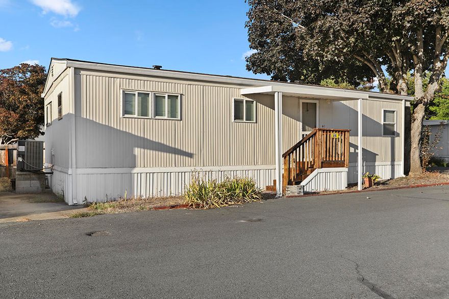 This cute double-wide is located at the end of the street on a corner lot and conveniently near the riverfront park!  The home is 800 sq ft with two bedrooms, one bathroom, and an extra room for your crafts, storage, or pet!  Relax in your home with a comfortable floor plan including a roomy living room and galley kitchen, or take a stroll down to the beautiful Rogue River right there in the park!  This is a quiet 55+ park with a nice, country feel yet close to town.  Don't let this one get away!  Schedule your showing today!