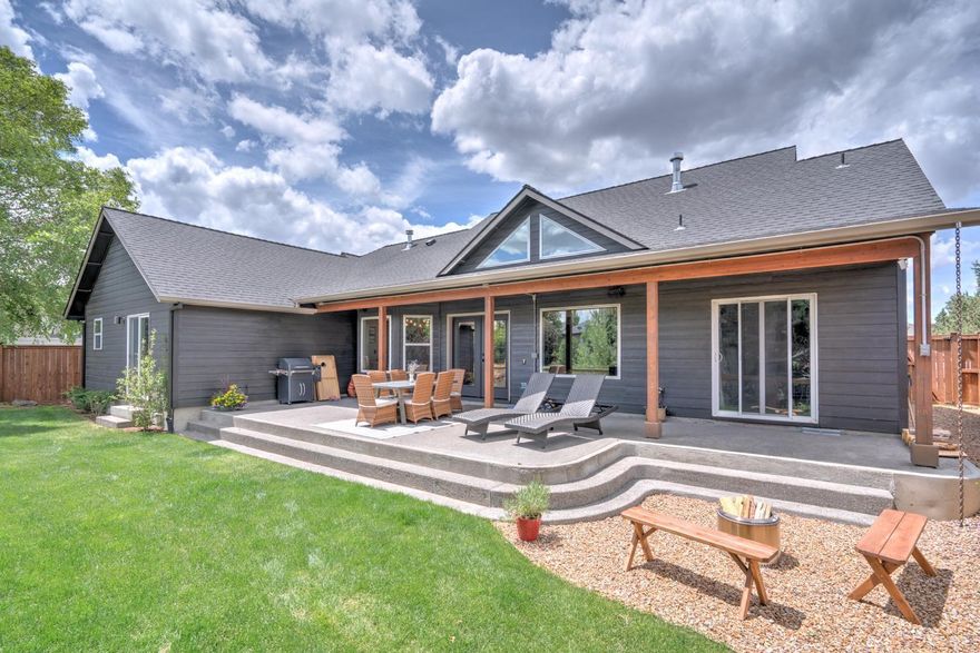 Beautiful single level custom home with three bedrooms plus an office in NE Bend! Built in 2003, this home offers 1,773 square feet of thoughtfully designed living space on a 0.20-acre lot. Step inside to an open-concept great room featuring vaulted ceilings, wood beams, hardwood floors with carpet insets, and a gas fireplace—perfect for entertaining. The gourmet kitchen boasts slab granite countertops, stainless steel Viking Professional stove, and a large pantry. An integrated sound system enhances both indoor and outdoor living spaces. The spacious primary suite offers a luxurious retreat with travertine tile, a soaking tub, double vanity, walk-in closet, and direct access to a covered patio. Outside, enjoy beautifully landscaped grounds with native plants, sprinkler system, and a tranquil setting overlooking the seasonal canal w/ walking path. No HOA and close to Pine Nursery! Listing agent is Seller.