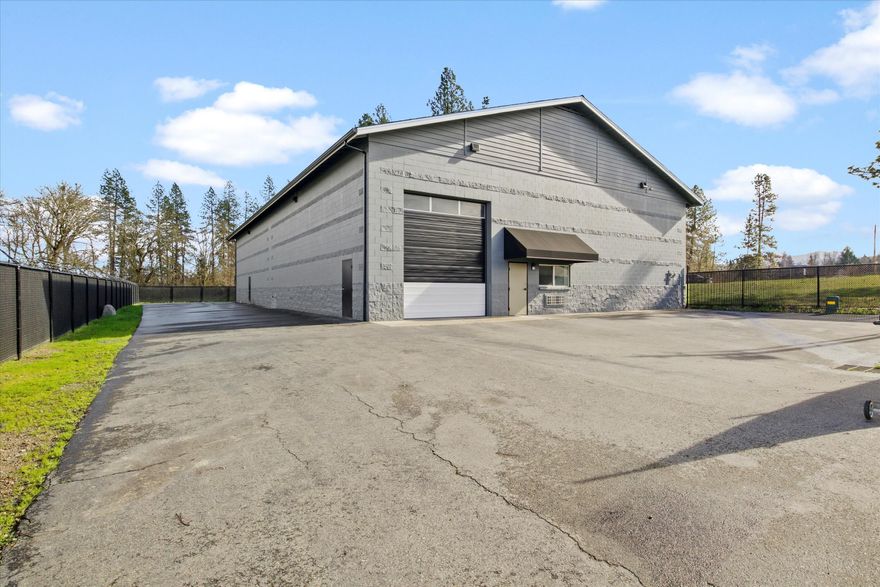 Centrally-Located and Spacious Commercial Property in Grants Pass! Situated in an extremely desirable area only steps from residential communities, this rarely-available commercial property affords excellent visibility from the ultra-busy Redwood Highway. Formerly utilized as a highly-rated automotive shop, the property boasts a 0.38-acre lot, fencing around entire building, paved parking, and a 7,100+sqft building. Constructed with concrete blocks, the building offers two oversized drive-through garage doors, exceptionally high ceilings, fluorescent lighting, a bathroom, and plenty of room for vehicle lifts, storage cabinets, work stations, and machinery. Keeping track of the day-to-day paperwork is easy with the upper-level office, which includes ample space for desks, filing cabinets, and customer seating. As a bonus, it is only moments from restaurants, RCC, and shopping. Fulfill your entrepreneurial dreams with this incredibly well-located property. Call now to schedule your tour