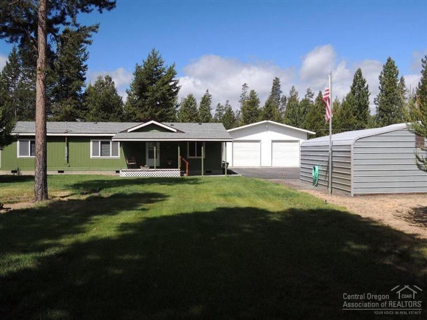 Pride of ownership shines throughout this home that is situated on Approx 1 acre backing to National Forest land w/direct gate access. Vaulted living w/pellet stove, built in China hutch & pantry. New int, ext paint & roof in 2014. 30x30 insulated shop/garage w/220 V Hookups, work bench, wood stove & covered cement patio. Also has a garden bldg, woodshed w/power that could be converted into a small horse barn & 18x21 dbl car steel carport. Nicely landscaped w/a paved driveway. Water softener & Heat Pump/