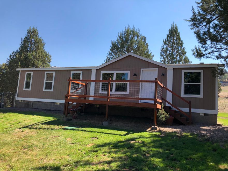 This home is like new with recent updates!  The kitchen is all new with alder cabinets, laminate counter tops & stainless steel appliances. New carpet in the bedrooms & new laminate flooring throughout the rest of the home. Bathrooms have new vanities & tubs. Freshly painted inside & out!  The pellet stove in the dining area helps with the cold winters.  Huge shop is a dream come true at 36 x 48 feet in size with 3 bays, 1 large enough for the RV or boat.  It is heated with a pellet stove, has a workshop area with built in shelving & loft area. There is room for at least 3 vehicles & all your toys.  There is no lack of storage with outbuildings, one is 16 x 16 ft storage shed, another is 12 x 24 ft pump house with storage.  Plus there is a hay storage & animal shelter with a fenced area for the 4H animals.  Deer fenced garden, landscaped fenced yard with automatic sprinkler system.  Enjoy the mountain views from the front deck. Deschutes River & Steelhead Falls are nearby.