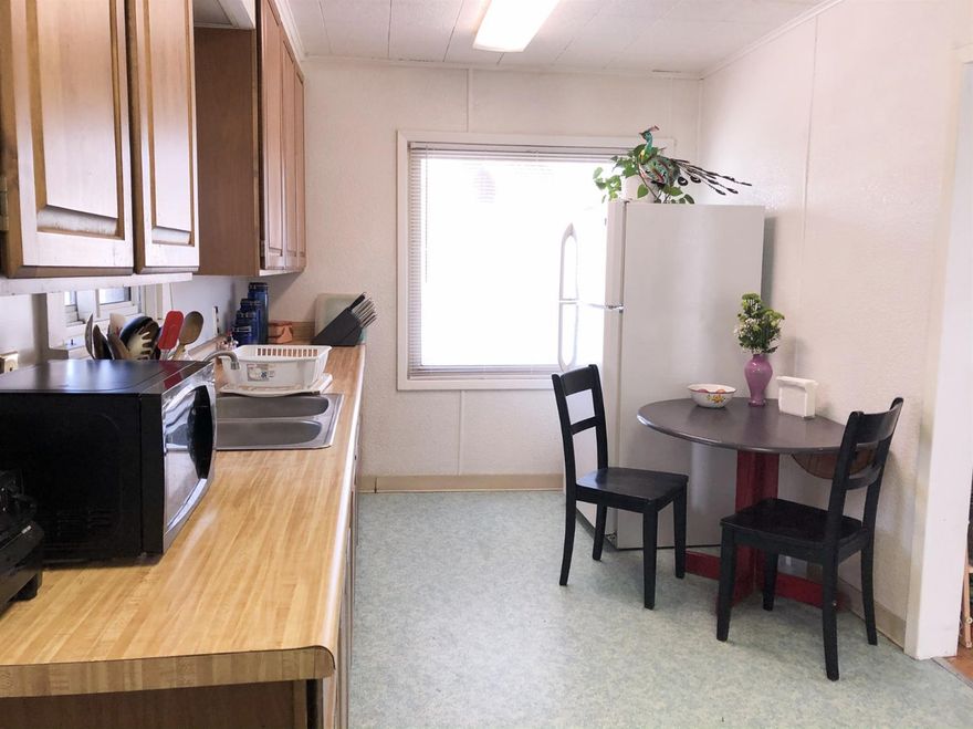 This cozy house in the middle of Klamath Falls has 1930s charm and an inviting covered front porch. It is fenced all the way around, with a rolling gate across the driveway entrance. In the kitchen you will find vintage vinyl flooring and plenty of cabinets, as well as two sunny windows. There is an indoor laundry room off the kitchen, with a door out to the carport. The yard has been lovingly cared for and includes roses, tulips, irisis, lavender, and a Santa Rosa Plum tree. Enjoy living close to downtown, grocery stores, and parks in a popular and walkable neighborhood.