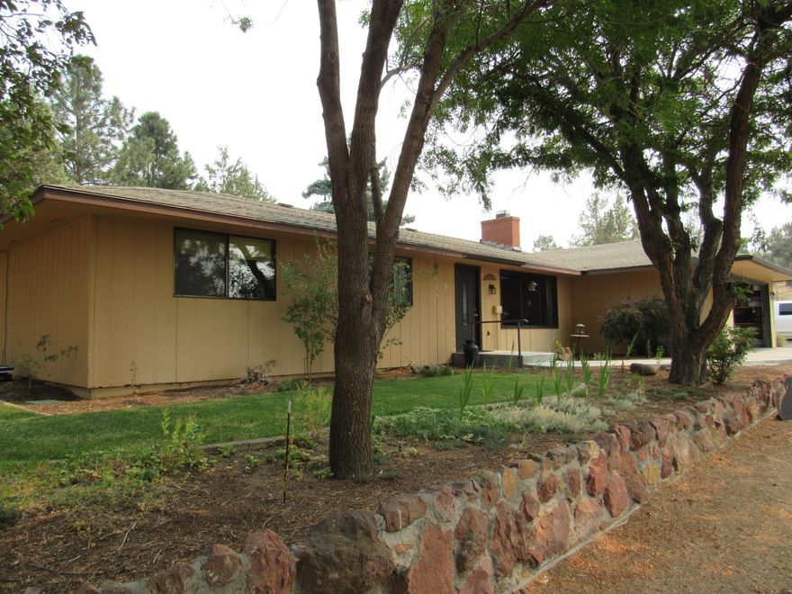 Well maintained home on 1.26 acres in popular North Madras Heights. Almost 2000 square feet all on one level with access ramps from two locations. A bonus room of over 100 square feet can be used a guest bedroom or a wonderful home office. A weatherproof deck is surrounded with railing that has low voltage lighting already installed. A concrete walk way goes from the house to a well constructed greenhouse. A barn/storage shed with attached stall is nicely situated next to the small corral. Whether for retirement, work from home, or raising active kids, this home is a good choice.