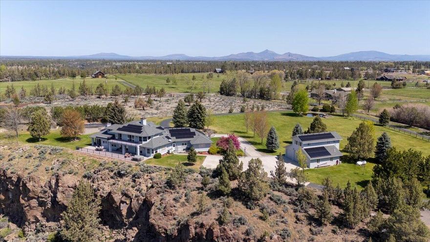 Welcome to this 5-bedroom estate, with 4,040 SF thoughtfully designed living space perched on the rim of the breathtaking Deschutes River. Set on 4.81 acres with 2.15 acres of irrigation, this property combines natural beauty, privacy, and luxury in one remarkable package. Enjoy the rare combination of river and mountain views from expansive patios abundant decking-perfect for entertaining or quiet evenings under the stars. Inside, two spacious primary suites provide flexible living options, ideal for multi-generational living or hosting guests in comfort. A standout feature of the property is the 1,816-square-foot shop with guest quarters, providing room for hobbies, work, or additional visitors. Whether you're seeking tranquility, space, or a base for adventure, this home has it all. Don't miss the opportunity to own this one-of-a-kind Central Oregon Sanctuary. Be sure to check out the video link!