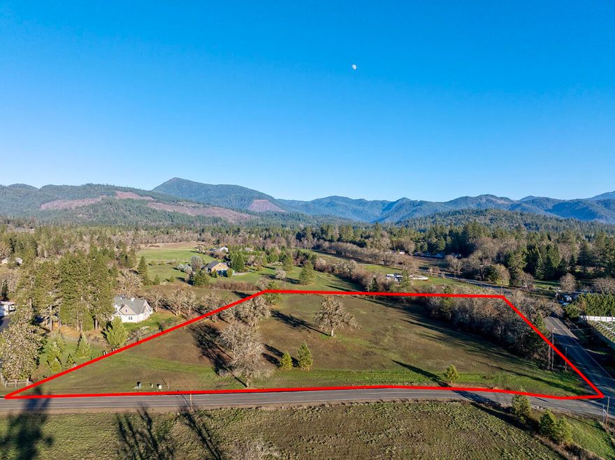 Level and open acreage with a view!  5.01 Acres on a corner lot with mountain views in a quiet secluded area of the the beautiful Illinois Valley.  ring your plans and start from scratch building your dream home!