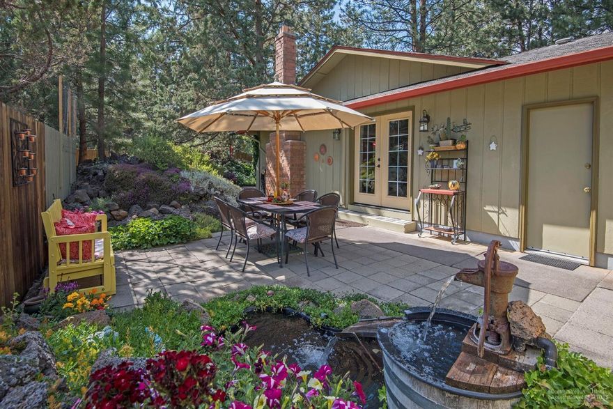 Perfect charm in every way. Quiet SW neighborhood, nestled in the pines. Updated kitchen with newer appliances, carpet and paint. Tile, warm & cozy wood burning fireplace, step out the french doors to the outside living area. Two beautiful patios, 2 water features, park like setting on approximately 1/2 acre. Manicured yard and garden area, RV parking, circular driveway, close to shopping. This is one of a kind with too many extras to mention. Sellers are downsizing.