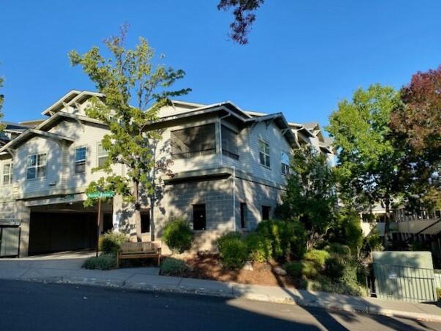 End unit with tall windows offering glorious mountain views! Located in the Mountain Meadows' 55+ Ashland resort style community. A $6904.00 credit will apply to buyer at closing towards condo & assoc. HOA dues. To help visualize this home's floorplan, virtual furnishings have been added to this listing. This unit features a spacious floor plan that includes a sliding glass door from the primary suite to a covered balcony. The kitchen is equipped with a pass-thru to the dining area, an elevated dishwasher for easy loading/unloading, as well as a large stainless-steel refrigerator. The spacious utility room offers plenty of storage space. The unit's location inside the main building offers easy access to the clubhouse, private dining room, fitness center, indoor heated pool and library. Short walks take residents to a robust community garden, fully equipped wood shop and community park. Mountain Meadows is a lovely community with many social/cultural events for residents. Come see today