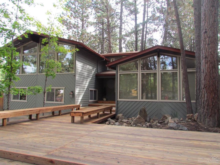 Wonderful Chalet home with tons of character on 1.23 acres of pine trees. Listen to the sound of the Deschutes river across the street. This home offers some nice updates and rustic touches throughout. Tri-level home has options for possible multi generational use. Hickory cabinets/ tile granite counters w/SS appliances in the kitchen. Floor to ceiling brick fireplace in the living room with a wall of windows for amazing natural light. Lodge pole accents, solid core doors, a large play room or additional living space on the lower level with cozy den, nice wood floors, additional bathroom and newer wood burning stove to keep you warm. So many nice features and opportunity to put your own stamp on it to make this property really shine! Beautiful landscaping with sprinkler system, hot tub, 26x28 shop with back of property access and plenty of room for your toys. Take a look at this amazing home which is on a paved road with so much to offer the buyer that has vision.