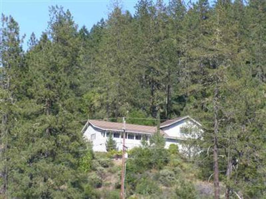 One of the most outstanding view homes this agent has ever listed in the Illinois Valley. Spacious 2700 sq. ft. ranch house with Brazillian Teak flooring; new carpet; new paint and granite counter-top in kitchen. Ceramic tile flooring in kitchen and bathrooms. Truly a great value including buildable 5adjoining 5-acres.Territorial and mountain views; spring fed pond; large game room and modern friendly custom kitchen. Enclosed deck that captures surrounding mountain vista.Even storage in crawl space. Bring the in laws or friends to build below this magnificent home site.