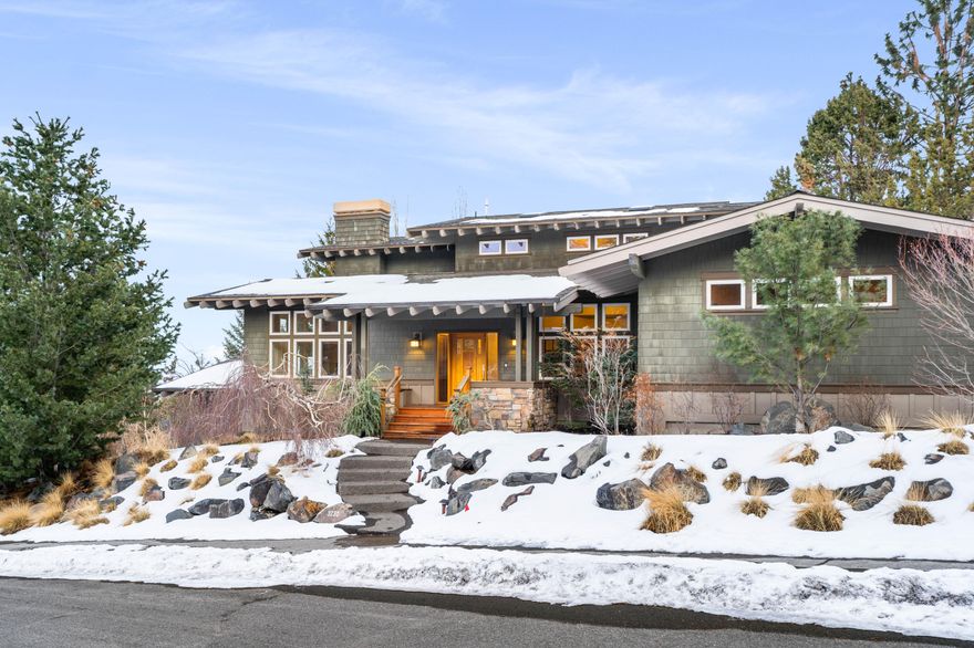 Nestled on a tranquil corner of Awbrey Butte, this charming craftsman seamlessly blends classic design with modern versatility. Expansive windows bathe the interior in natural light while a cozy fireplace framed by custom cabinetry infuses warmth & character to the space. The gourmet kitchen features stone counters, premium appliances & a spacious center island—ideal for gatherings. The main-floor primary suite offers a jetted tub, heated bathroom floors & french doors leading to a dedicated office. A wrap-around mahogany deck extends from the kitchen, creating an inviting outdoor sanctuary with soothing water feature. The home's thoughtful design features a versatile bonus room on each level, insulated interior walls, surround sound & humidifier/air cleaner. Sweeping eastern skyline views, miles of nearby river trails & a central west side location provide the perfect backdrop to a full Bend life, while recent updates (AC in 2024, fridge, washer & dryer in 2022) offer peace of mind.