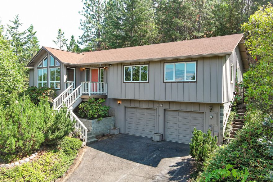 Contemporary home with tongue and groove vaulted, beamed ceilings, big floor to ceiling windows and mountain views set on .29 ac lot. Enjoy the cozy spaces in this 1993 built house with 3 bedrooms + office, 2.5 bathrooms, spacious den, and sunroom, lower-level craft/office with attached powder room. The eat in kitchen features plentiful storage, in a wooded setting are just a few of the custom features of this property. The primary suite is spacious and private set toward the back of the house and away from the living spaces. Terraced back yard accessed by a lovely deck and patio has mature plantings and provides a quiet and serene place to relax. Enjoy the nearby hiking trails and be just a few moments from close by shopping. Attached 2 car garage with add storage.