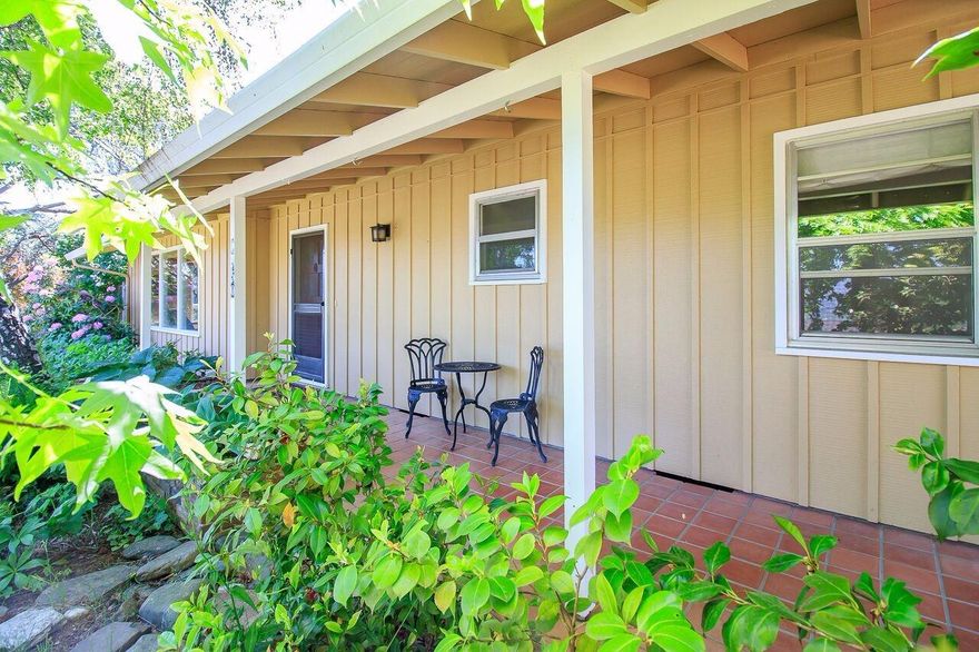 Expansive views way above the Boulevard with direct access to your favorite trails from the backyard!. Private lot, .33 acre with TID, mature trees and terraces already built in. A covered entry lined with warm Spanish tiles welcomes you to this beautiful Ashland Home. Easy living all on one level with additional private sunroom with access to the backyard. New kitchen cabinets, stainless steel appliances and convenient dining area. Relax after dinner in the cozy living room next to the wood stove and enjoy the beautiful views across the valley. The original wood floors have been refinished along with new carpeting. Recent exterior paint and metal roof will keep move in costs low. Extra set back next to the garage offers space for smaller recreational vehicles and equipment access to the back yard for any potential improvements. Come see it today!