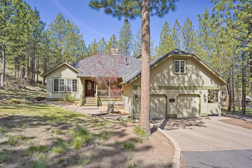 Gorgeous Awbrey Butte home! Nestled on a park-like setting over an acre, surrounded by trees. Enter through a welcoming covered porch into a Great Room floor plan with vaulted ceilings, floor-to-ceiling windows, contemporary new light fixtures and gas fireplace. This home has four true bedrooms and an office, as well as a giant bonus room. Large second floor primary suite with dual vanity and walk-in shower. Kitchen feels fresh and inviting with white cabinetry, granite countertops, stainless appliances and island. The large deck is ideal for entertaining directly off the dining area. Relax in the hot tub and listen to nature and the peaceful sound of the incredible water feature. Curbed driveway leads to a flat area and an oversized two-car garage. Paver pathways and low maintenance landscaping. Nearly new roof, and furnace. Central air conditioning. Recently painted throughout. Park and tennis courts across the street. Impeccable inside and out!