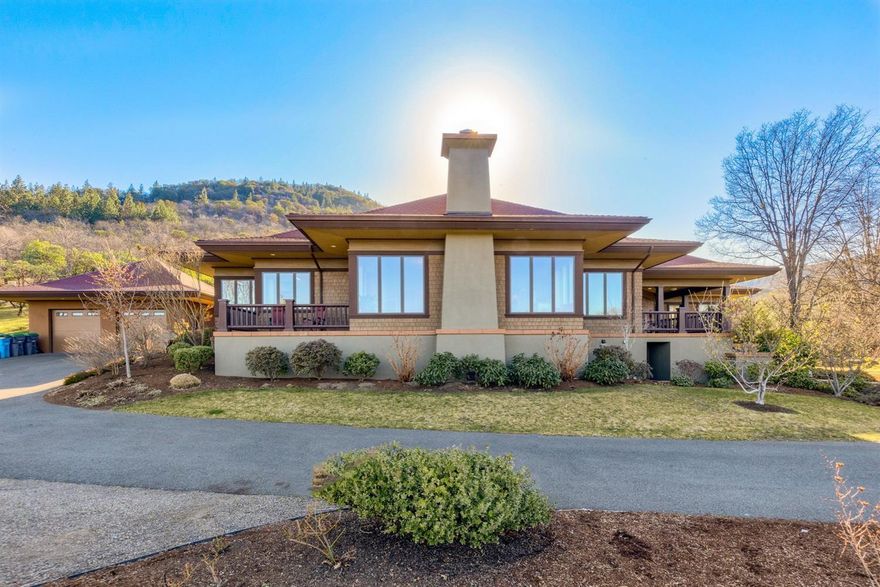 This magnificent, single level Ashland estate is located just above Lithia Park and The Plaza in the desirable Strawberry Lane area. Quality construction, exquisite attention to finishes and detailing, extraordinary views of the Cascades, Grizzly Peak and the valley make this a remarkable home. Custom built with designer skylight, high ceilings, herringbone patterned wood floors, quality craftsmanship & lighting and an abundance of built-ins. Walls of wood framed windows bathe rooms in natural light. The large open living room with beautiful Beech wood floors has a gracious woodburning fireplace and inviting corner window seats. The gorgeous master bedroom has numerous windows which overlook the beautifully landscaped, private backyard. The spacious master bathroom features a soaking tub, separate shower, separate vanities, sauna and a large walk-in closet. There are 3 generous guest bedrooms plus 2 additional rooms allowing for 2 offices or 1 family room and an office.