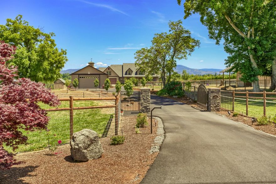 Stunning Craftsman-Style home w/Northwest flair! Built 2013 by Signature Homes. 2.43 irrig acres w/gated entry. 4,096 sqft home has open floor plan, hickory wood floors, 20 ft ceiling in great room, floor to ceiling rock accented gas fireplace w/built-ins including LED accent lighting. Formal dining room. Fabulous kitchen w/oversized island, 6 burner gas range, dbl ovens, rustic knotty alder cabinetry, microwave drawer & lg pantry. Master suite has private office/den, lg bathroom w/ beautiful tile & marble shower & 2 shower heads and walk-in closet. 5 spacious bdrms upstairs, bonus room/den & 2 bathrooms including second laundry rm/mechanical rm. Oversized/extra deep 2 car garage plus a finished 1200 sqft detached shop w/front & back 12 ft high doors. 16x32 Gunite in-ground salt water pool, heated w/gas & electric heat pump, automatic safety cover, 3 fountains. Landscaped w/lighting on timers, solar lights down driveway. Desirable Jacksonville School District.