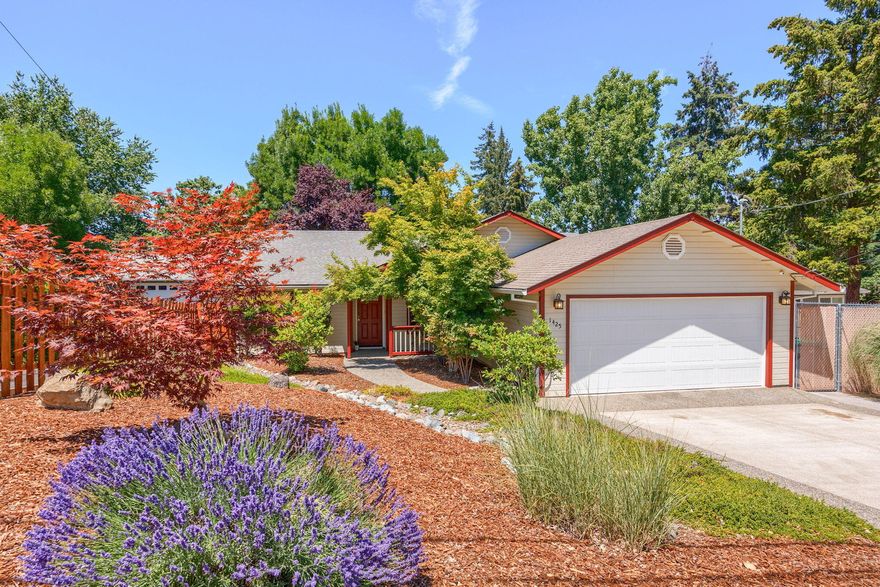 Lovely, single-level home on a quiet street that is just blocks from the 10 acre Donahue-Frohnmayer Park. The welcoming entrance brings you into the open living room of this three bedroom, two bathroom home with charming arched entry ways to the kitchen, dining area and hallway towards the bedrooms. With vaulted ceilings, the sense of spaciousness is wonderful. The bedrooms enjoy a nice separation from the living area, allowing for privacy. The spacious primary bedroom has an en-suite bathroom and walk-in closet. Outdoors provides privacy and quiet with mature landscaping, shade trees and a large deck for relaxing and entertaining. The oversized attached two car garage is insulated with a mini split heat pump providing heating and air conditioning keeping it comfortable for projects year round. This home has been well cared and is located in a wonderful East Medford neighborhood ready to move right into. Don't miss this wonderful opportunity!