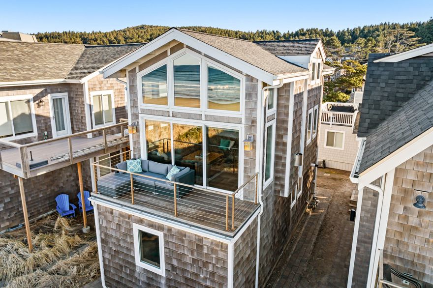 Beachfront Luxury with Private Access & Haystack Rock Views.Wake up to waves and panoramic ocean views in this stunning Cannon Beach retreat. With direct beach access, a private dune, firepit, and expansive ocean-facing deck, this custom-built home offers the ultimate coastal experience. Nestled in a quiet yet convenient location, it's just minutes from Fresh Foods, Sea Level Bakery & Café, and Mo's. A reverse floor plan maximizes breathtaking views, featuring a vaulted living room with floor-to-ceiling windows, gas fireplace, and seamless indoor-outdoor flow. The gourmet kitchen boasts Viking appliances, custom cabinetry, and honed granite.
This thoughtfully designed home includes two primary suites, three baths, and a versatile third-level loft. Radiant heated floors, a jetted tub, Apple Home connectivity, and smart features ensure comfort. No HOA! Meticulously maintained, never rented—experience carefree beachfront living.