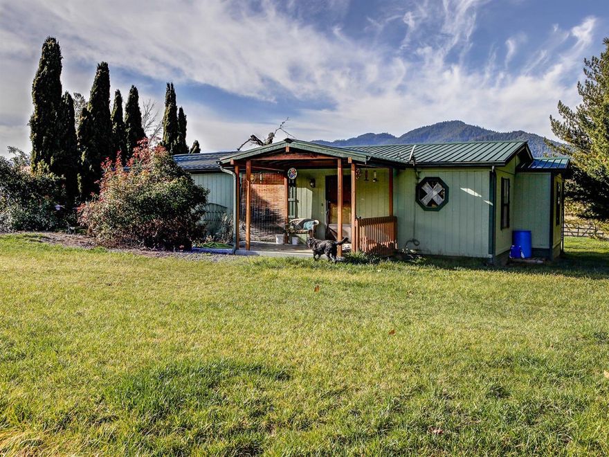 Bring your animals. Flat 5 acres with great farmsoil per owner. 3 bed 2 bath manufactured home with walk-in closet and garden tub in master. Nice deck for enjoying the views and relaxing. Oversized 2 car detached garage with 8x10 hobby shop, 20x20 utility barn, 18x52 rabbit barns, 36x60 ten stall barn with turnouts and auto waterers in most stalls. 2 carports one double one single. Three 16x20 garden hot houses with six raised beds per house.