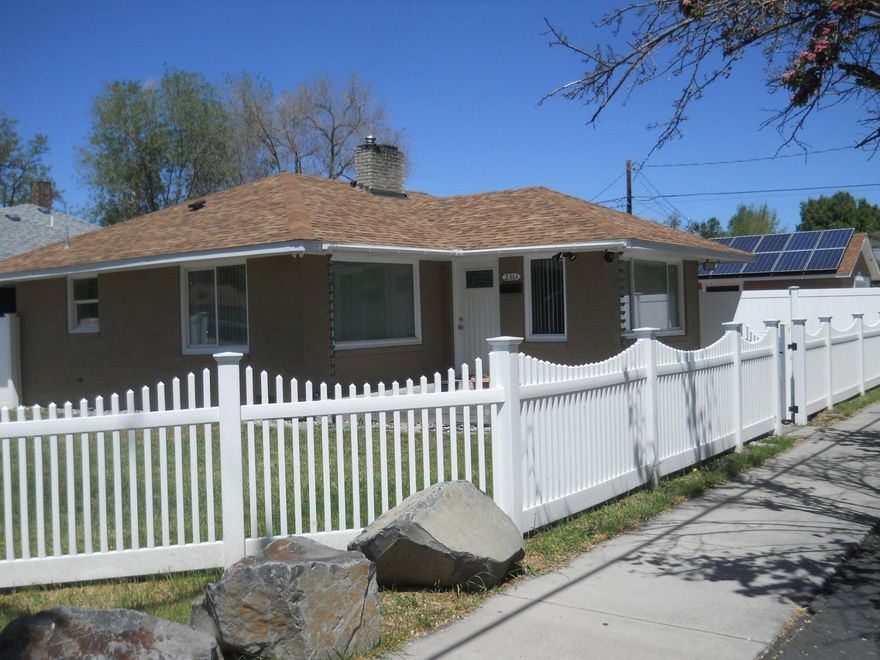 Mid-century bungalow lovingly restored with some modern upgrades. There are 2 bedrooms, and a small swing room suitable for nursery or office, formal dining room, and living room with fireplace. 3.975kW grid-tied solar array has been making excess power donations to Energy Trust of Oregon since 2017. Full specifications and production history available. Hardwired 4k/6MP capable video security system with infrared illuminators. Newly remodeled kitchen with cork floor, custom cabinets and Corian countertops & tile backsplashes. Fridge, stove, dishwasher and microwave inclu.  Laundry hookups are adjacent to kitchen & accommodate gas or electric dryer. Newly remodeled bath with cultured marble vanity top, new vanity, sink, toilet, &  tile. There are new red oak hardwood floors, fireplace, & plenty of built-in space for your linen and books. Fenced yard front & rear. Gas heat w/ programmable wifi thermostat. Detached 2-car garage/shop with electric openers and remote w/ adjacent brick patio