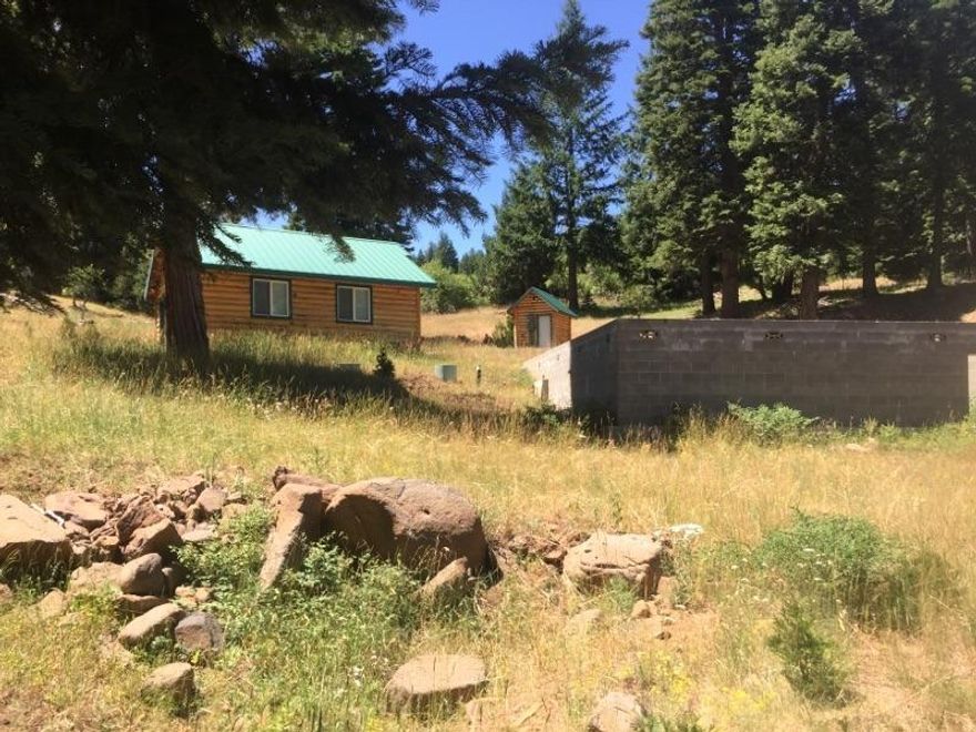 Opportunity to build a private retreat in beautiful, peaceful setting close to Hyatt Lake. Two car garage with 1/4 bath and log siding. Septic installed plus RV dump. Well tested an average of 24 GPM in 2013. Existing foundation for 1800 square foot dwelling. Two seasonal creeks run through this 5.05 acres that also backs to BLM land. Enjoy year-round recreational activities before or after you build! Utilities are buried underground - less chance of outages during a storm plus no unsightly power lines! Floor plan available to review.