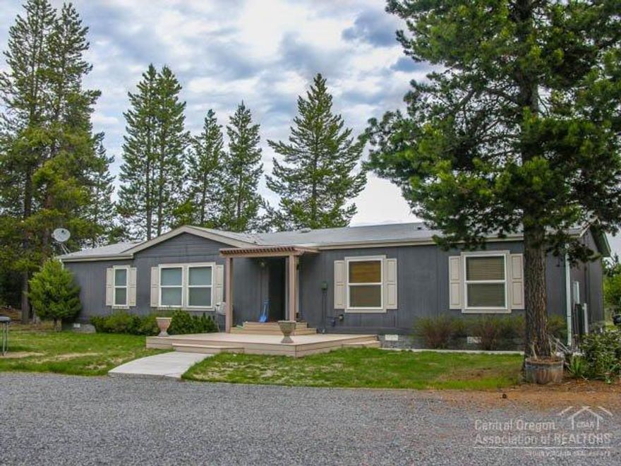End of Road Privacy Backing BLM Land with Shop! Features 4Bd/2Ba, ~1800sf, RV cover w/hookup, 24x36 garage/shop wired w/220v & fully insulated, cement walk ways, covered Trex porch, tiled entry, wood lam flooring, great room w/pellet stove & tiled hearth, open kitchen/dining area w/tiled b-bar, tiled counters, center island, pantry & skylight, laundry/mud room, big master w/walk-in, private bath w/dbl tiled vanity & skylight, white vinyl fencing & security fence in front & huge back deck w/great BLM views!