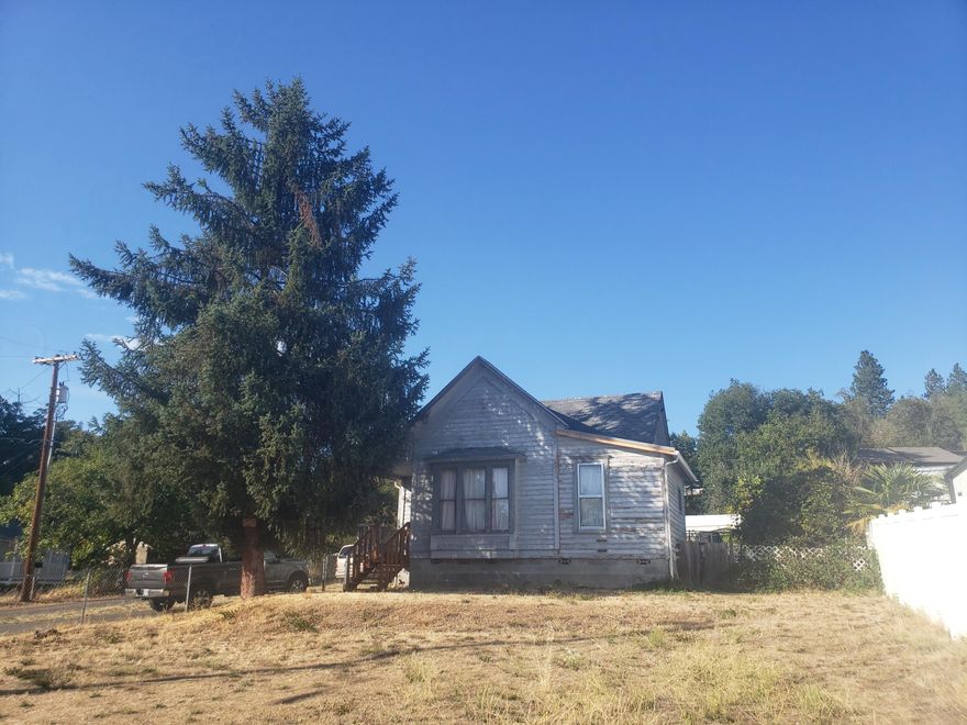 Great location just west of town. .43 acre lot is nearly level, is partially fenced, has a paved driveway, city services, and has long range views to the south. The home is suffering from a lack of maintenance and is in need of repairs. The leak in the front bedroom has been fixed. Damage is all inside cosmetic now. Home is being sold AS - IS, and Seller is asking for cash offers only.