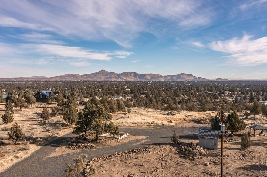 5.2-acre parcel offering sweeping Cascade Mountain views to the west and stunning territorial views of Smith Rock to the east. This dual-level property provides rim-quality views from the upper portion and a truly turnkey build site below on Lot 17 SW Pheasant Place in Terrebonne. A rare combination of completed infrastructure and flexible building potential. The property features a producing well with a constant-pressure pump (~50 PSI) and well house, 400-amp electrical service with a high-KVA transformer, and a 1,520-gallon standard septic system engineered to support a future home, ADU, and shop with a bathroom. The parcel has been fully graded and flattened, offering an immediate head start for construction. Included are plans for a 20x20 shed and a 20x20 lean cottage—currently in permitting, needing only roof truss engineering for final approval. Exceptional ready-to-build opportunity in a prime Terrebonne location.