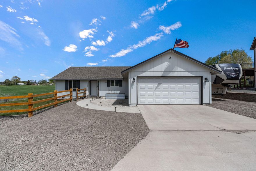 This inviting ranch-style home nestled on a spacious .22-acre corner lot is positioned to capture gorgeous skies with mountain views and has uninterrupted neighboring pasture views! The yard is fully fenced, the property has fresh gravel and bark dust, and there is ample RV parking! This home offers the best of country-style living with suburban convenience! The spacious living room offers single-level living with an open floor plan, 3 beds, 2 baths, a good size laundry room, new exterior paint, new lighting, new bathroom vanities, new fans, and new kitchen appliances! In addition to the insulated 2 car garage, a shed has recently been added for more storage! Come see it for yourself—this one won't last!
