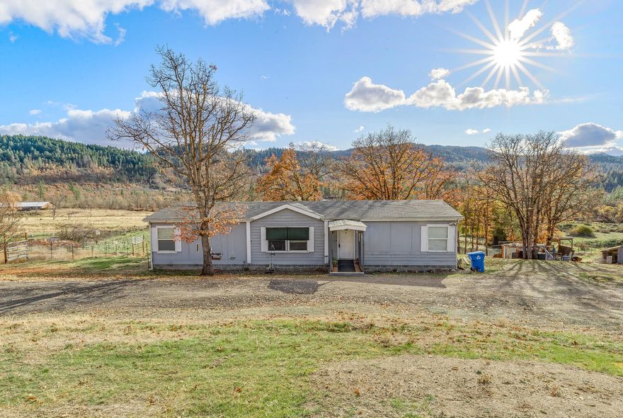 Country living on 10.10 acres with 3 acres irrigated, fenced and cross fenced, zoned EFU. 1999 built, 3 bedroom, 2 bath manufactured home.