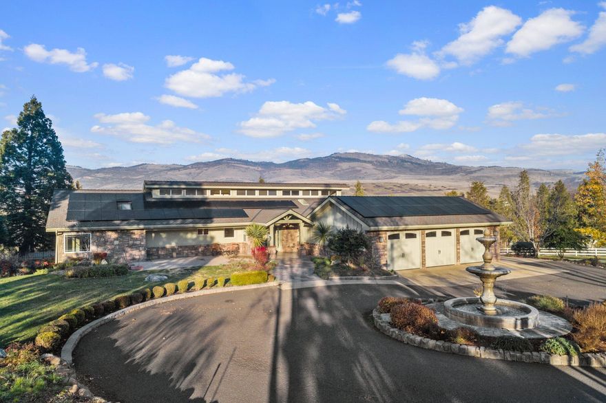 Welcome to your dream horse property! Step onto the property and be taken away by breathtaking 360-degree mountain views. This exceptional 5 1/2 acre home offers everything you need for a perfect two family set up, with plenty of space for your equestrian needs. Panoramic views are enjoyed from over 2000 sf of new decking. Enjoy the mare motel, 3-acre sprinklered TID Irrigated pasture, chicken coop, garden beds and even a Golf Putting green - all with full RV hookups! Inside is just as luxurious, featuring an open floor plan on both levels. Upstairs has 2 bedrooms and an office! The master bathroom has a beautiful tiled steam shower and stand alone tub. Downstairs features a huge living room with studio attached plus separate entrance - perfect for guests or extended family. And don't forget about the heated 3 car garage with 220 hookup plus 55 solar panels that will bring $400 of monthly savings to you! With well flow at 40gpm+, this is truly an amazing place to call home