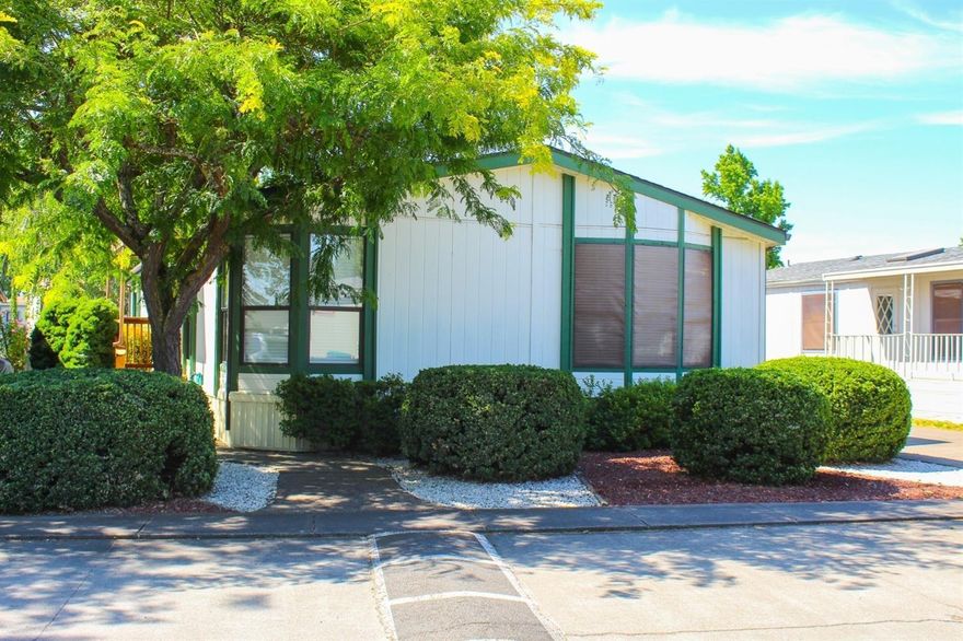 Myra Lynne Manufactured Home Community is one of the nicest family parks in Jackson county with a community pool, club house, park and grounds that are well taken care of. This home is on a beautiful tree lined street with a lovely yard full of colorful flowers and nicely cared for lawn on a sprinkler system. The kitchen has lots of storage and a pantry. The master has 2 closets, double sinks in the bathroom and new floor and toilet and lots of plug ins. The second bathroom has a new tub/shower. The heat pump is 2 years old, water heater is 3 years old, steps to entry on both sides are newly refurbished and the shed has power. Buyers must be approved by the park.