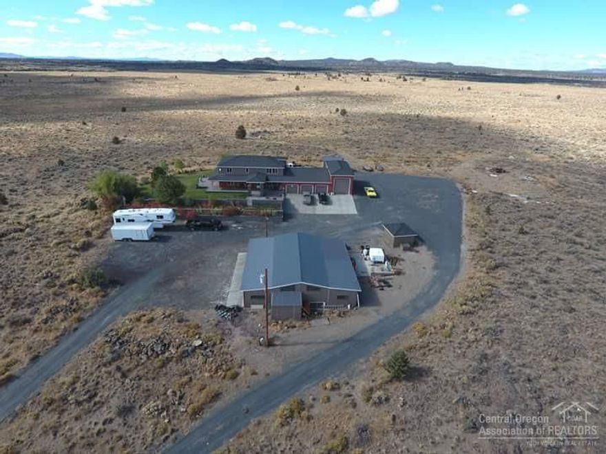 The stunning panoramic views from this custom built home are endless. Pride of ownership on this 3000SF 3bed 2.5ba home w/updated master bdrm, new flooring in living room & updated kitchen, large family room, office/den that could be 4th bedroom, indoor spa/hot tub room, large 4 car garage with indoor RV parking that has 50AMP service, landscaping with extensive decks, storage buildings & a 36x48 4 bay shop. This amazing property is close to hunting, fishing & 10 miles from the Christmas Valley Sand Dunes.