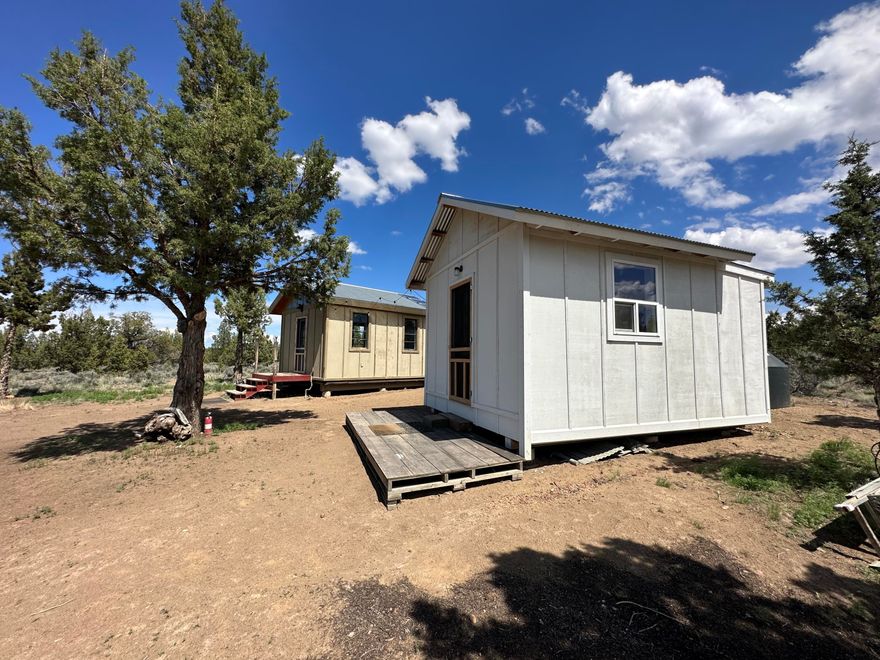 Escape to your ultimate off-grid retreat! This dream fishing/writer's or recreational cabin offers panoramic Cascade Mountain views and is a haven for nature enthusiasts. Two masterfully crafted living space cabins including one homey timber frame building, exude rustic charm and thoughtful functionality. Enjoy sustainable living with an excess of 300+w solar panels to each cabin, a 300 gallon cistern, LED lighting, and a backup generator. Fully embrace the off-grid life with a charming outhouse with a composting toilet. This 10 acre lot is fenced on 3 sides and situated just 5 miles to Prineville Reservoir and the Crooked River... endless outdoor adventures await! Take advantage of the septic approved ''vested right'' CUP, option to live in cabins while building your dream home. Explore this unique opportunity to take advantage of seller financing options. Discover serenity and beauty in this secluded oasis!