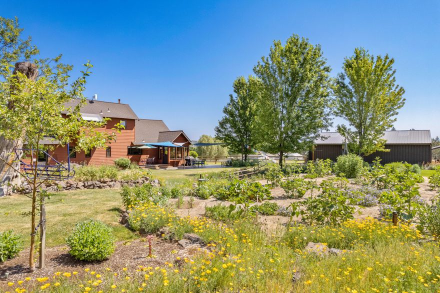 Welcome to this Charming Farm in Bend, OR. This lovely home features a desirable layout w/a private primary suite, for added privacy. You will find an engaging loft located in the 3rd bedroom & a sunroom off of the kitchen area. The property offers ample storage & living space, w/ a 2-car garage that includes a finished 567SF Art Studio. Additionally, the barn is equipped w/ a shop & 3-12x12 stalls,+ 23ft. deep storage garage + covered storage, providing plenty of room for hobbies, & additional equipment /vehicles. The grounds are meticulously maintained, boasting luscious vegetable garden, large pond, native landscaping, old mill artifacts showcasing tranquility in the surrounding outdoor spaces. The Tumalo Water Rights are all ran by underground sprinklers for easy use! This is a dream property you dont want to miss!