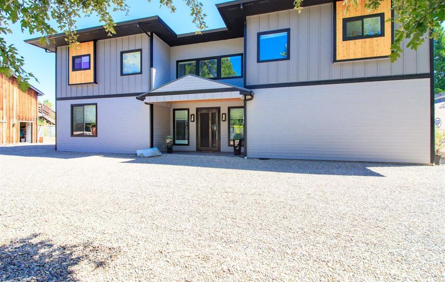 Beautiful contemporary home & guest house on large lot in historic Jacksonville. The main home is 4,192 sq. ft. with 3 Master bedrooms & bathrooms & 2 half baths. Tiled entryway leads to a very open & airy kitchen, dining & family room. Kitchen has quartz countertops, a large island w/raised bar & black stainless steel appliances. Family room boasts a floor to ceiling custom gas fireplace. Windows in the kitchen family room are remote control windows with remote control shades as is the telescopic sliding glass door. Bathrooms have custom cabinetry, quartz countertops & custom tile work. Main master bath has heated tile floors & large walk-in closet. From the second floor there are beautiful views of the valley & surrounding mountains &rim of Crater Lake. Some of the other amenities are LED lighting throughout, fire suppression system, home gym & theatre. The guest house sits over a three car garage & rents for $1,600 a month.