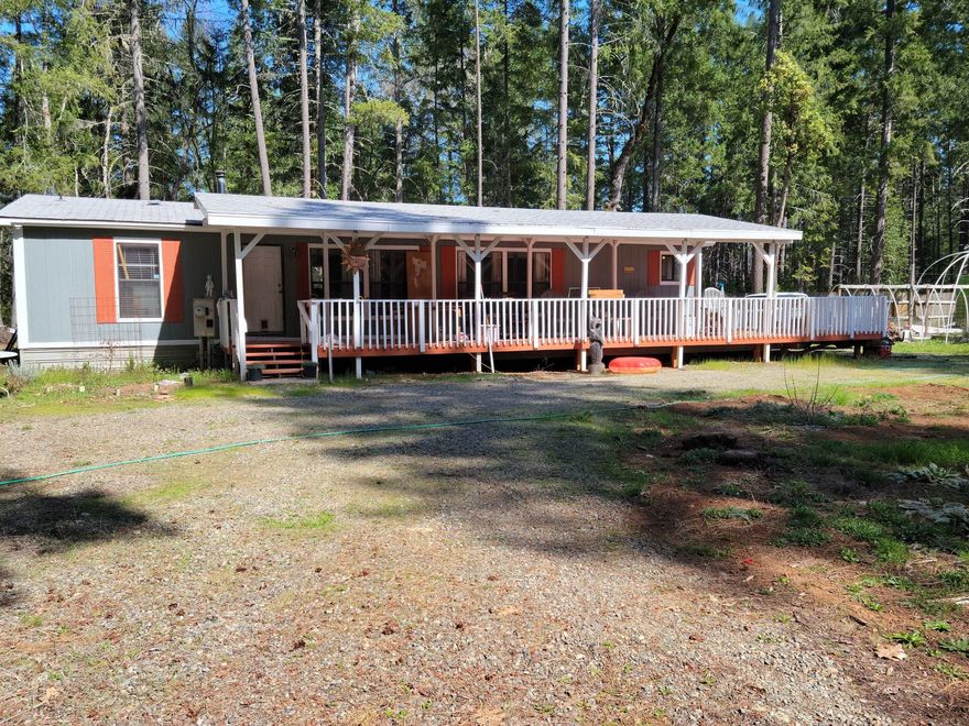 Almost 7 private acres with 1991 manufactured home. Three bedroom and two baths 1456 square feet. Sit on your deck and take in the peace an quite. Nice large garden area.  Property is gated with a circular drive way.