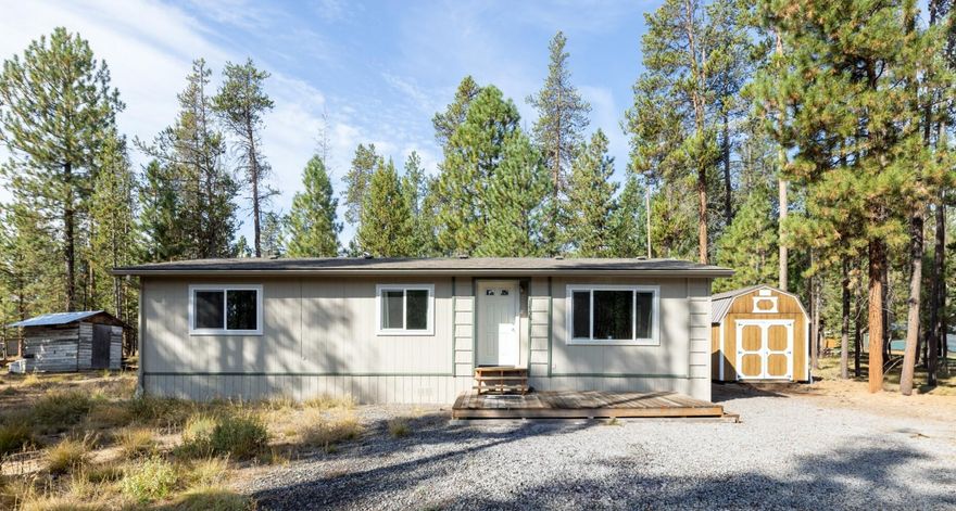 OWC - Move-In Ready Home in Desirable Wagon Trail Ranch - Furnished - Special financing available with Preferred Lender—rates as low as 4.125% for qualified VA buyers! Escape to Central Oregon with this move-in ready 2 bed, 2 bath manufactured home on a 1.17-acre lot. Fully furnished, it's located in the sought-after Wagon Trail Ranch, a community offering a clubhouse, pool, and private access to the Little Deschutes River—ideal for full-time living or a peaceful getaway. Major updates are complete: well and septic (2017), plus new heat pump, indoor coil, windows, insulated doors, and laminate flooring (2022). A 30-amp RV hookup with water makes hosting simple, while a 10' x 16' shed provides storage for tools, gear, or toys. Inside, enjoy a clean, bright layout with abundant natural light. Outside, the spacious lot has room for RV parking and outdoor living. This property blends comfort, convenience, and recreation in one great package. Don't miss your slice of Central Oregon today