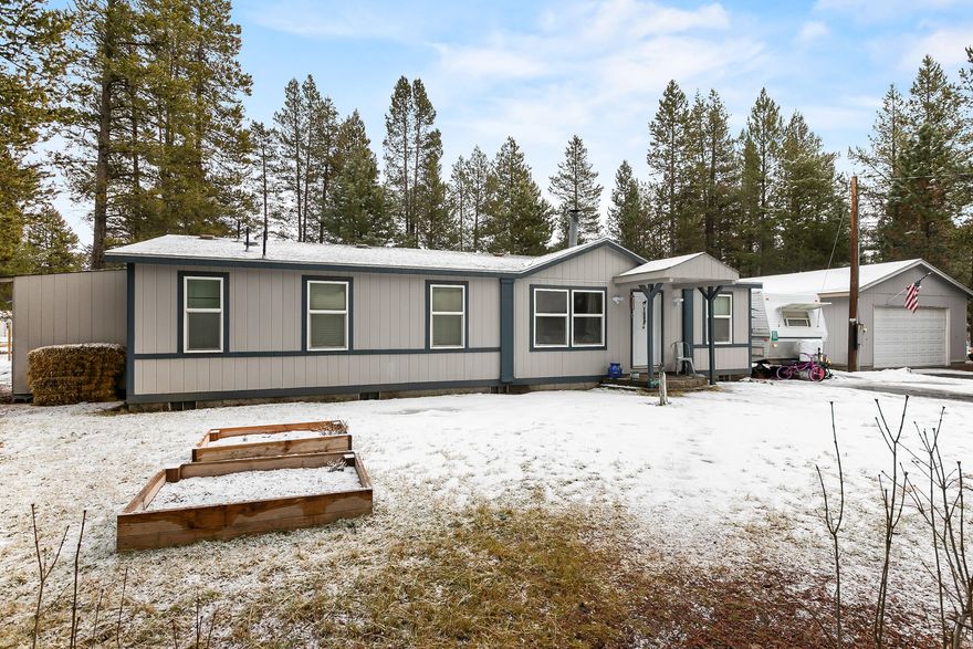 Location & Privacy in the heart of Central Oregon! The home is situated in the center of the property, surrounded by mature pines. Home features an open floor plan w/tons of natural light. Efficient wood burning stove in the open living area w/plenty of space to entertain. Recently updated w/chestnut wood look laminate flooring, new trim & paint. Open kitchen w/plenty of counter & cabinet space for storage. Spacious master suite w/french doors into the bath, complete w/dbl vanities, shower & corner soaking tub. Step outside w/sliding glass doors onto the covered back patio & grill area. Property is well maintained w/space & shelter for your animals. Close enough to town for shopping and services & still just minutes from Class A fishing, skiing & all the wonderful recreation Central Oregon is famous for. Space for storing all the toys, equipment or hobbies. Circular driveway, raised flower beds & RV Hookups. Plus a detached garage & storage building for storage.