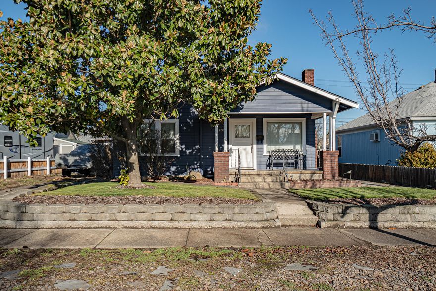 Must See This Charming Medford Home! Located on a quiet street, close to schools, shopping, and downtown. Enter through the inviting covered porch to 1052 sq ft, wood burning fireplace, hardwood floors, 2 bedrooms, 1 bath, large kitchen and updated cabinets. The home offers many updates including newer electrical, vinyl windows, gas forced air heating system, roofing, cabinets and countertops. The back yard is spacious and completely fenced with a great patio and and entertaining area, complete with a fenced garden area. Single car garage and large parking area in driveway. This adorable home is ready for it's new owner to move in!