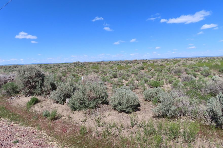 Almost 10 acres on paved road for you to make your own.  Great location on the way to the famous dunes.  Enjoy the high deserts beautiful sunrises and sunsets. Watch the wildlife as it meanders through as well. C.U.P. likely required to build.