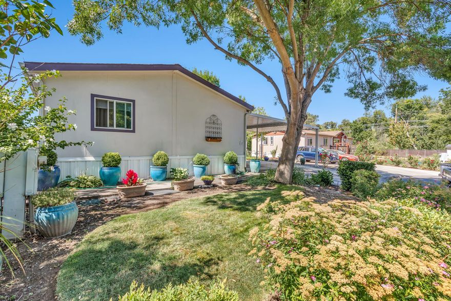 Amazing spacious home in the San George Estates, an all-aged park located on a cul-de-sac. This 3 bedroom/2 bath home features an open / split floor plan, with hard wood flooring, vaulted ceiling and skylights, ceiling fans, sitting room / office, master bedroom with large master bath - soaking tub, shower and double sinks, good sized Livingroom, large dining room, and the kitchen is very spacious with oak cabinets, island, dishwasher, 2 guest bedrooms, and bath, separate laundry room . Large deck, newer roof, carport for 2+ vehicles, and the park offers a variety of amenities such as clubhouse, swimming pool, playground, exercise facility and RV storage.