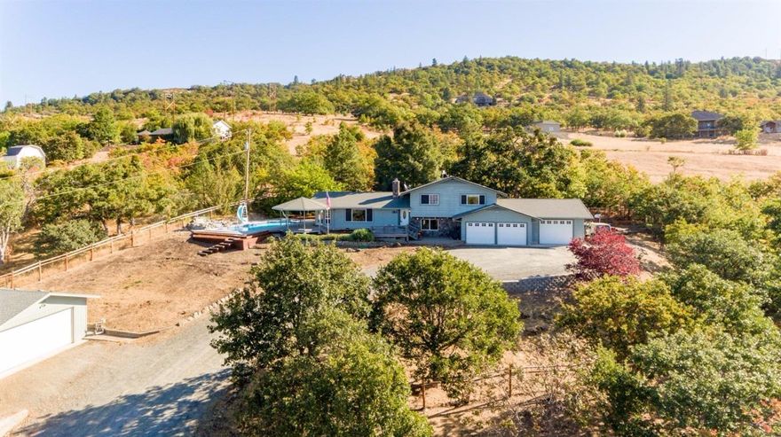 Great Location just outside of Medford with incredible valley views. Over two acres with a fenced pasture area, large detached shop (approx 520 SF in enclosed), covered RV parking and a 900 + Sq Ft 3+ car attached garage. There is plenty of space for all your toys. Open floor plan with granite counters in the kitchen and laminate flooring in the living and dining rooms. Great natural light throughout. French doors lead to the exterior gazebo, deck and in ground pool with water feature. There is a separate living room, bedroom and full bath downstairs, perfect for overflow guests. Spacious master suite with walk-in closet and dual sinks in the bathroom.