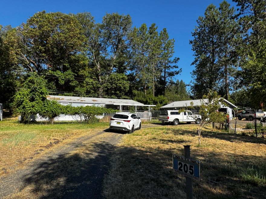 OPPORTUNITY!!!   This 3/2 home on over an acre is just waiting for someone ready to put in some cleanup.   Home is on a solid concrete block foundation, good well and city sewer.   Includes double deep 2 car garage with bathroom.  Lot has privacy in the back and a historic old barn with several sheds.   Tear out carpet, bring your paint and haul some debris off and you've got equity in the bank!