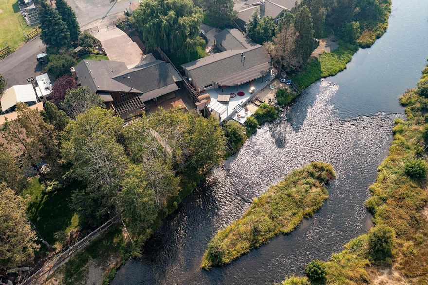 Deschutes Riverfront location in the heart of Tumalo and just minutes to recreation & Bend. Relax in your private riverfront oasis. Step off your deck to fly fish, kayak or float the day away... Fall asleep to sounds of the river. Stroll (1/8 mile) to downtown Tumalo for a coffee, dinner & drinks, shopping, fresh fruits & veggies, workout class or salon treatment. Vaulted open floor plan with plenty of natural light and BIG river views from living, dining, kitchen & master! New roof 3 years ago, high-end laminate flooring, many new windows, new interior painting and upgrading throughout. One bedroom/full bath downstairs. Irrigation rights in addition to Laidlaw water. Heat pump. Tons of parking. Fully fenced. Private paved road. Dog kennel area. Thriving turnkey airBnb!