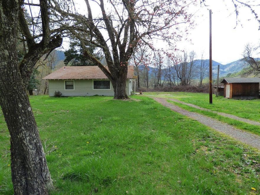 Nearly 12 acres of prime EFU farmland. GPID for water. Nice solid home with basement. Home was renovated in 2000: vinyl windows, carpet, paint, tile etc. Just minutes from the city of Rogue River. Barns have fallen down here and will need to be cleaned up/rebuilt (cement floor in large barn is good per owner) This property has a ton of potential!