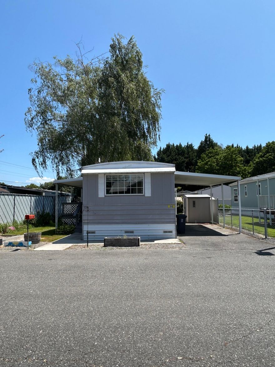 This delightful 2 bedroom, 1 bath, 924 sqft home offers comfortable low maintenance living in the serene setting of Country Village Mobile Home Park, a 55+ community. With two spacious bedrooms each featuring built in storage and one well appointed bathroom. The bright and open living area is filled with natural light, the kitchen includes plenty of cabinet storage and a convenient breakfast bar. Covered front porch and covered parking with a small shed for storage. Come see all this wonderful home has to offer!