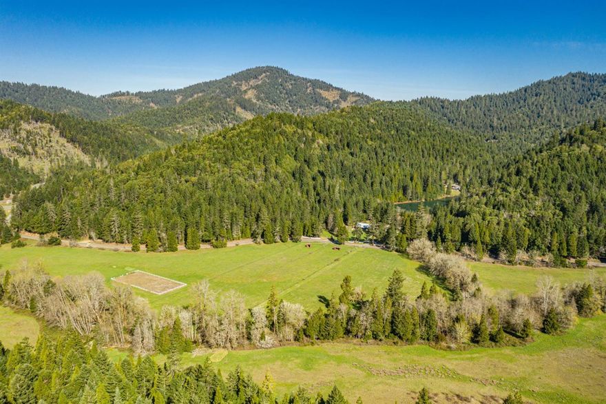 The Sourdough Gulch ranch features 809 acres, 4 homesites, miles of trails, & abundant wildlife. The land is diverse & includes forests with a mix of majestic evergreen trees, treelined meadows, two live water streams, pasture, & a stunning 4.5-acre lake. As you enter the main gate & travel past the ranch headquarters, you meander through mature trees, to the main home, situated overlooking the lake. The home features 2,800 Sq. Ft., 4 beds/2.5 baths, & an open concept living space. The ranch headquarters includes a ranch house, barn, & equipment storage. +/- 20 acres of pasture with quality loam soils. 24.6 acres of primary & 14.1 acres of supplemental water rights. The property will be conveyed subject to a conservation easement held by the S. Oregon Land Conservancy. The easement will protect the conservation values of the property, such as the forests, streams, & riparian areas, & will keep the property intact while allowing for low-impact recreational use of the land.