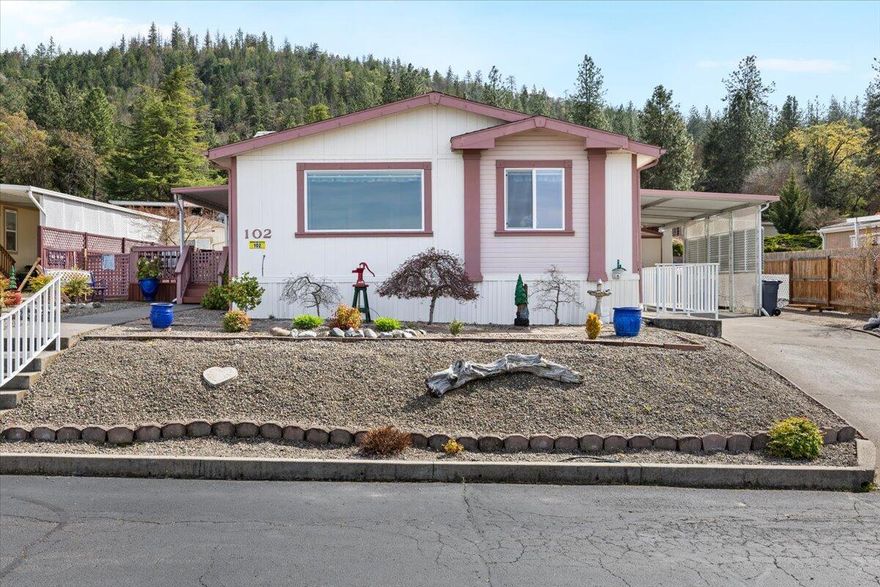 PRICE REDUCED $15K! Wake up to BREATHTAKING VALLEY VIEWS every morning in this well cared for manufactured home at Western Carriage Estates - the premier 55+ community just minutes from historic Jacksonville! One of the largest lots in the park offers your private oasis with stunning panoramic vistas of valley, city lights and iconic Table Rocks. Soaring vaulted ceilings and open concept living showcase floor-to-ceiling windows that frame nature's masterpiece. Gorgeous kitchen highlights custom hickory cabinets. Two generous bedrooms plus flexible den/office space/third bedroom. Luxurious primary suite features private deck retreat, walk-in closet, spacious bathroom with double vanities and walk-in shower. BRAND NEW HEAT PUMP means year-round comfort! Active community offers a fantastic clubhouse space, a pristine seasonal pool, regular social events and fitness classes. RV parking is available. Don't miss this rare opportunity for effortless living with million-dollar views!